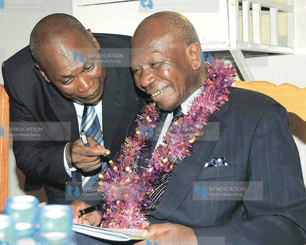 Vice President Moody Awori (right) consults with the Commissioner of Prisons, Gilbert Omondi