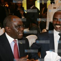 Assistant Minister David Musila (left) with Nation Media Group CEO Linus Gitahi