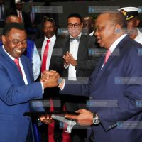 President Uhuru Kenyatta receives a commemorative plaque