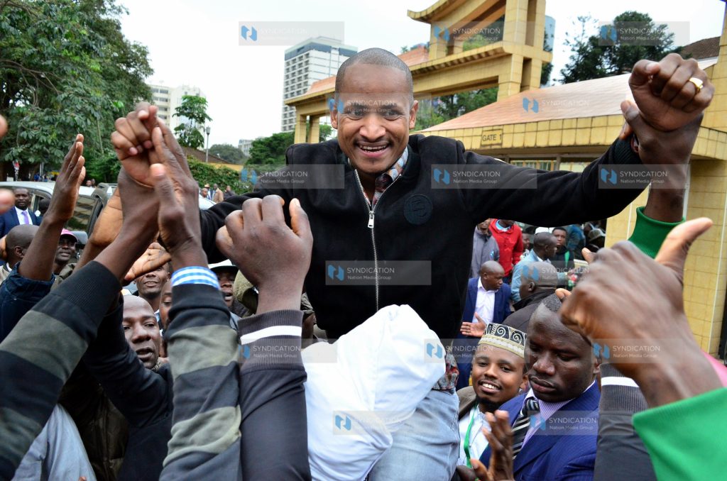 Babu Owino is held up by his supporters outside the Supreme Court