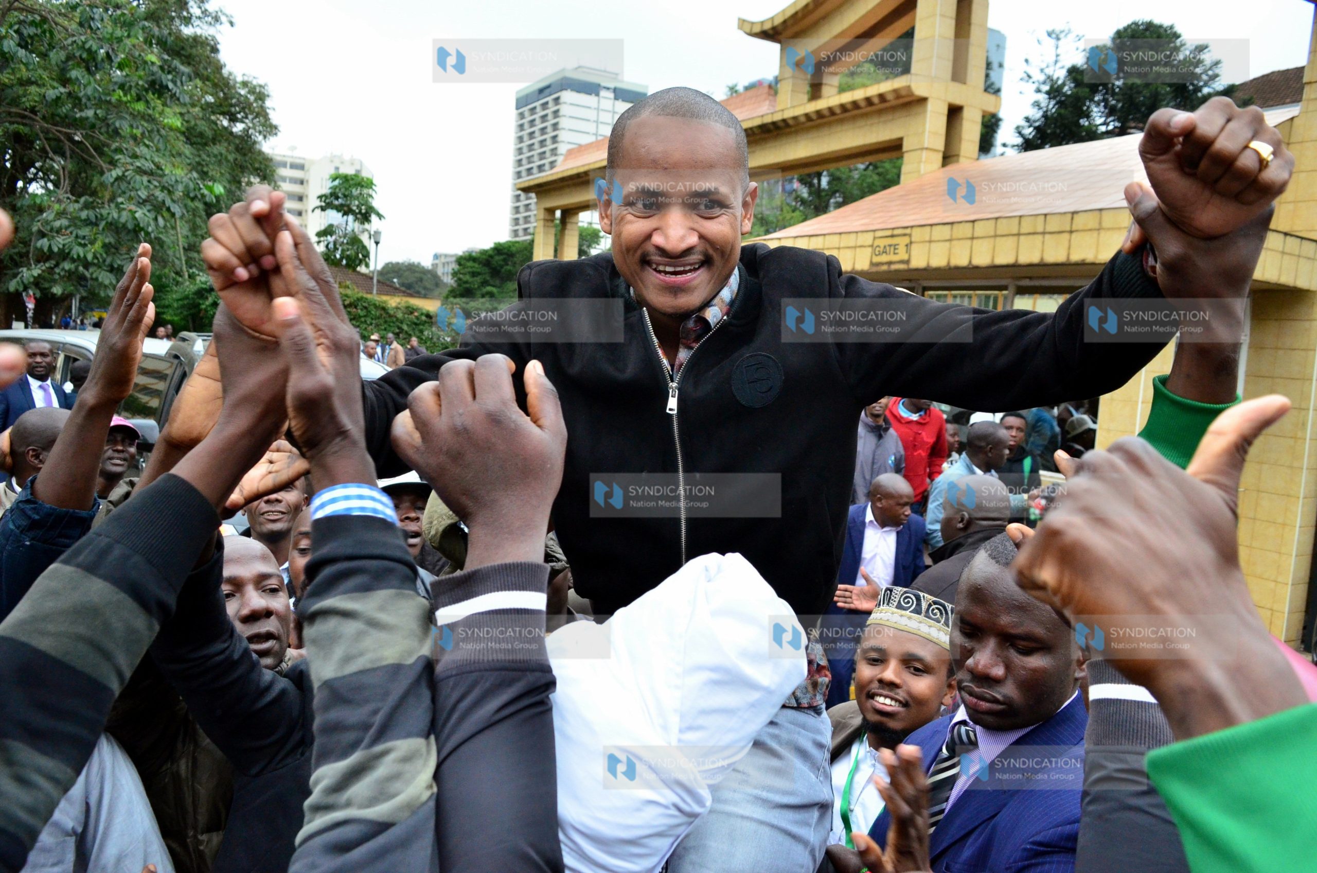 Babu Owino is held up by his supporters outside the Supreme Court