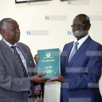 Meru governor Kiraitu Murungi (Right) receives the pending bills report