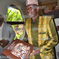 Moody Awori with the book Life Journeys Scaling the Heights