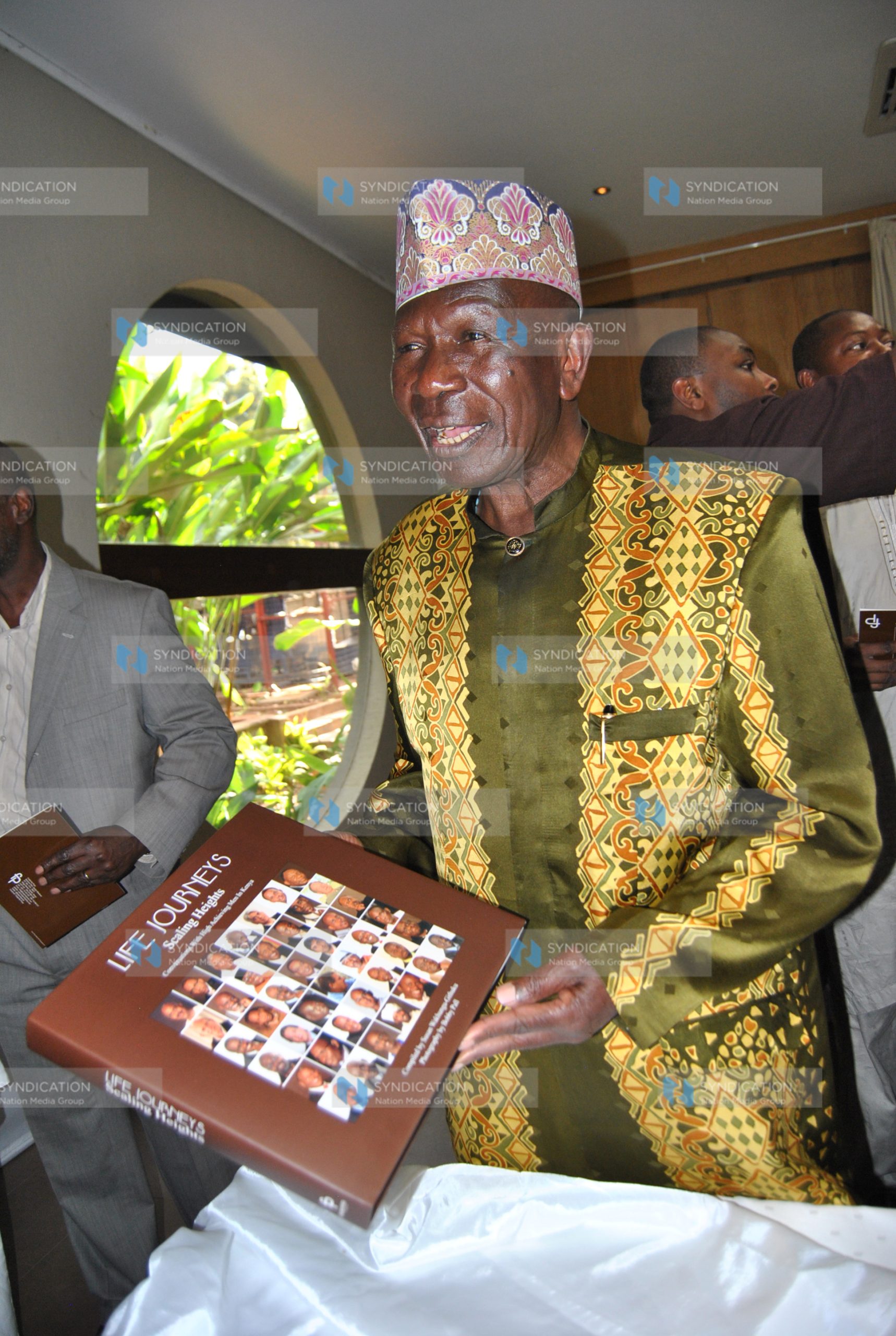 Moody Awori with the book Life Journeys Scaling the Heights