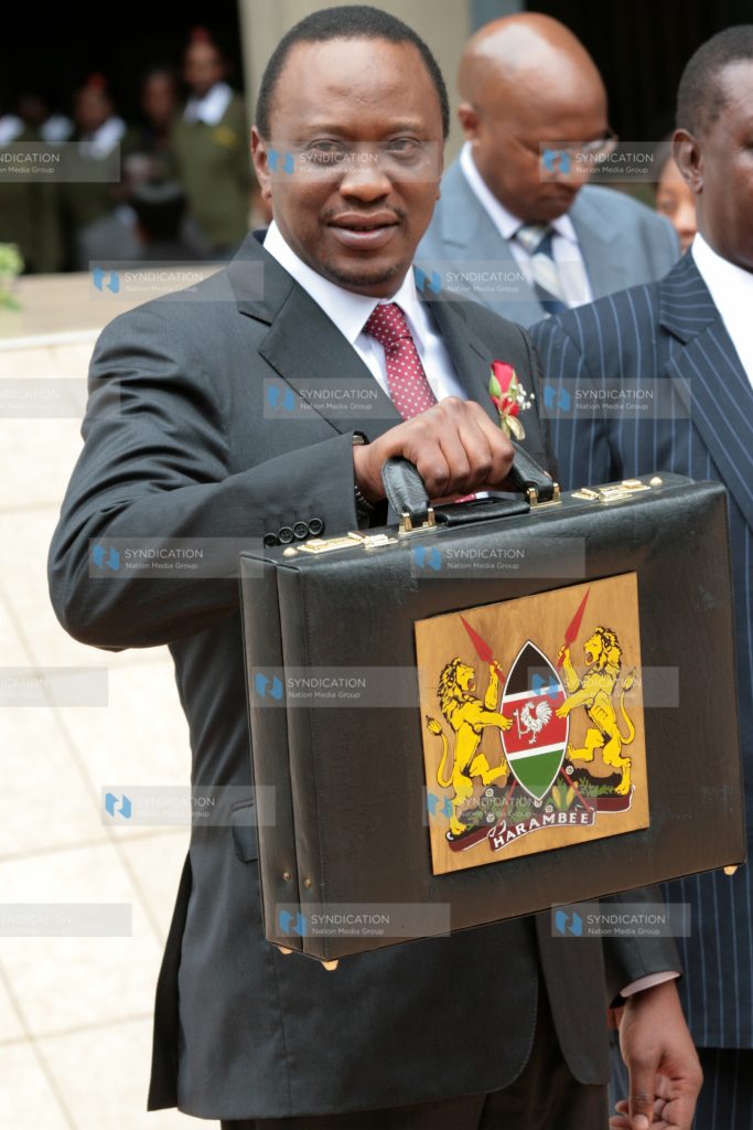 Finance Minister Uhuru Kenyatta poses for photos