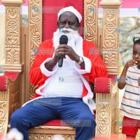 Raila Odinga speaks to a group of children at his home in Riat, Kisumu County