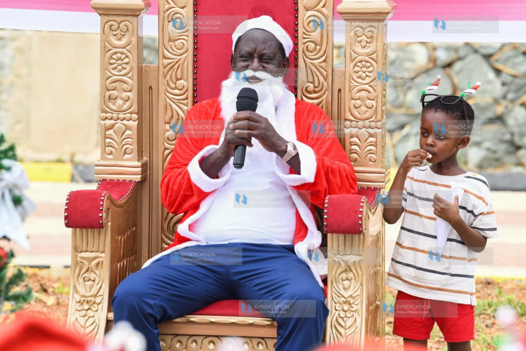 Raila Odinga speaks to a group of children at his home in Riat, Kisumu County
