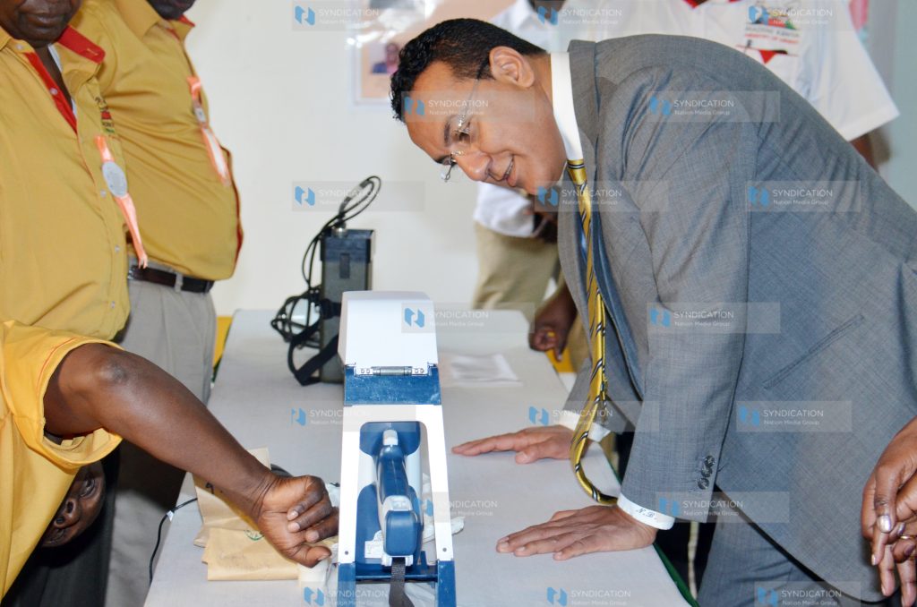 Najib Balala (right) is shown the procedure in in extracting minerals