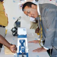 Najib Balala (right) is shown the procedure in in extracting minerals