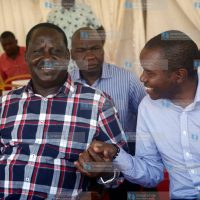 Former Prime Minister Raila Odinga speaks with ICT Cabinet Secretary Joe Mucheru