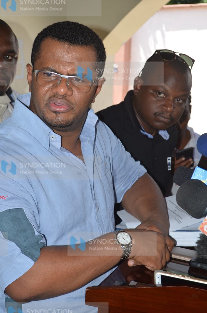 Former Mombasa Senator Hassan Omar (left) adddressing journalists