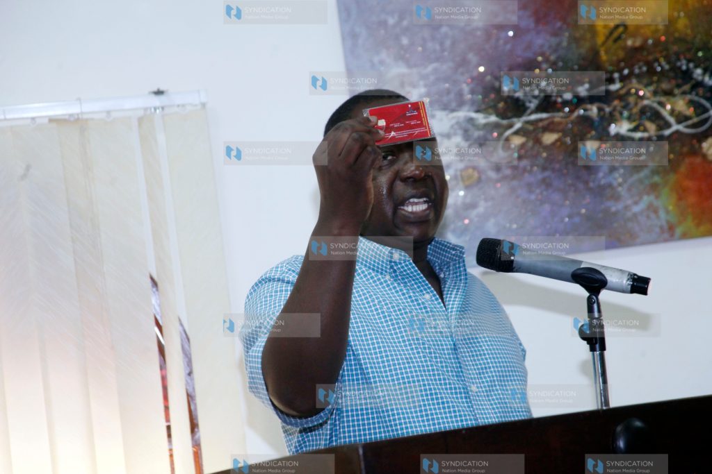 Dr. Fred Matiang'i displaying the new biometric card