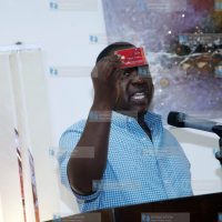 Dr. Fred Matiang'i displaying the new biometric card