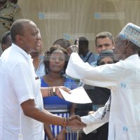 President Uhuru Kenyatta issues a copy of title deed