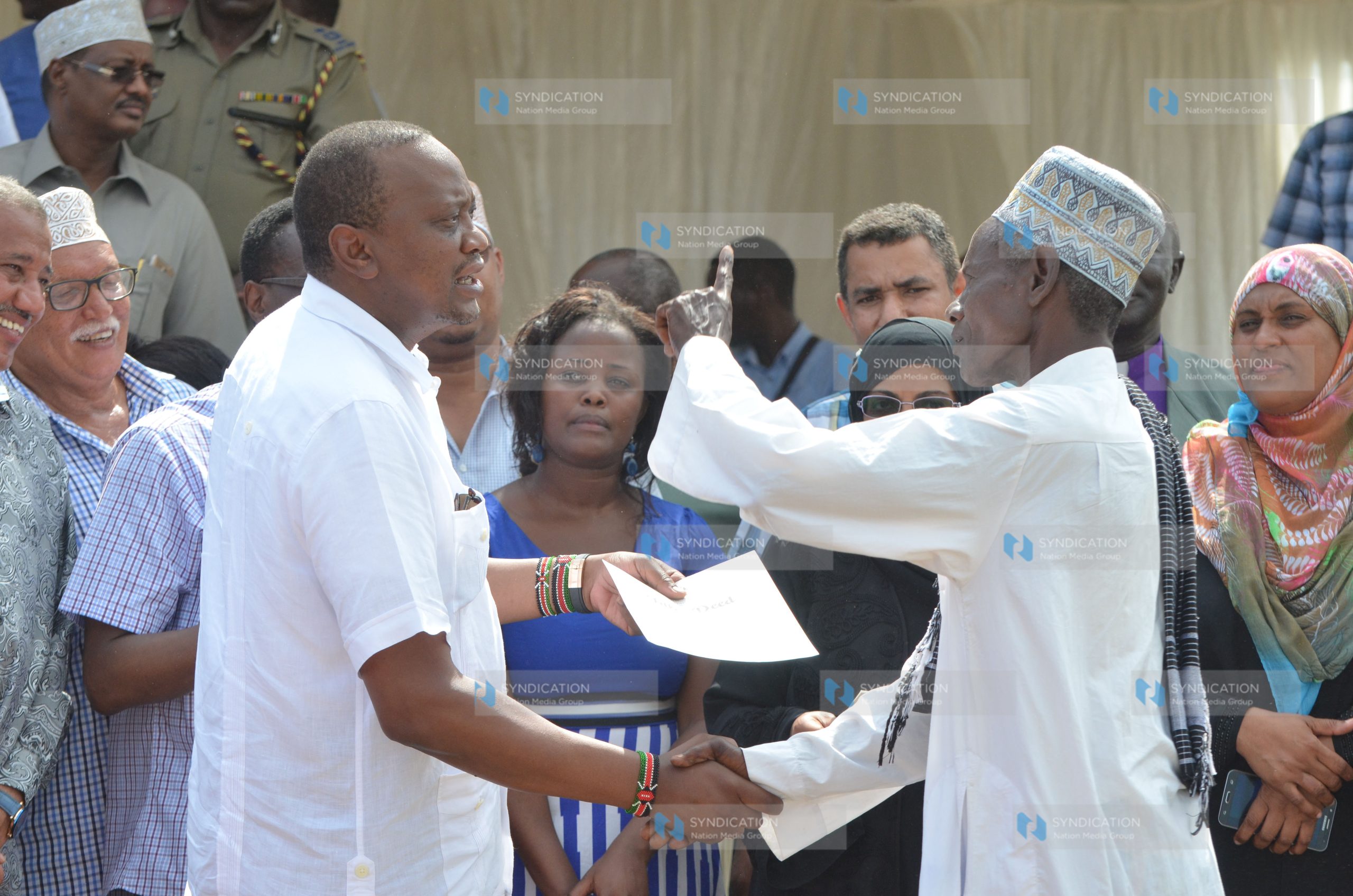 President Uhuru Kenyatta issues a copy of title deed