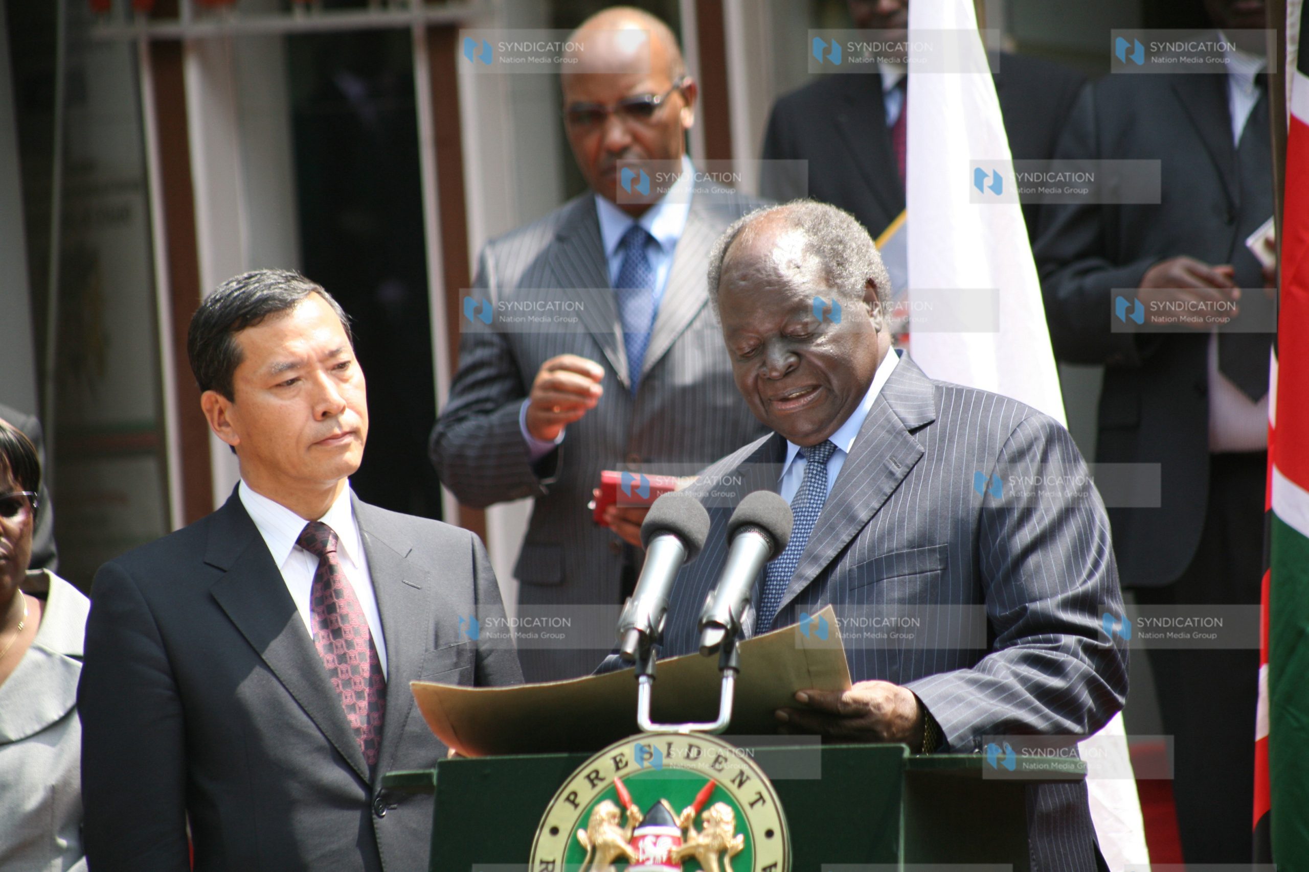 President Mwai Kibaki presents a donation of US $1 Million to Japanese ambassador Toshihisa Takata