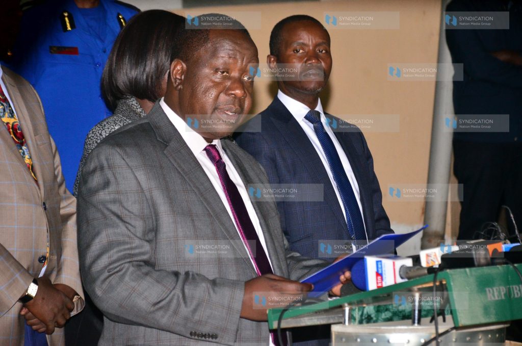 Dr. Fred Matiang'i (left) addressing media
