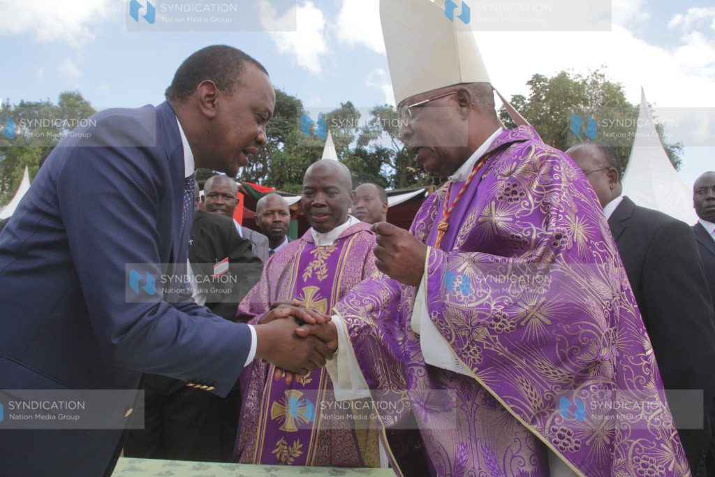 President Uhuru Kenyatta has a word with Cardinal John Njue