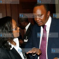 Deputy Prime Minister and Minister for Finance Uhuru Kenyatta speaks with Capital Markets Authority Chief Executive Officer Stella Kilonzo