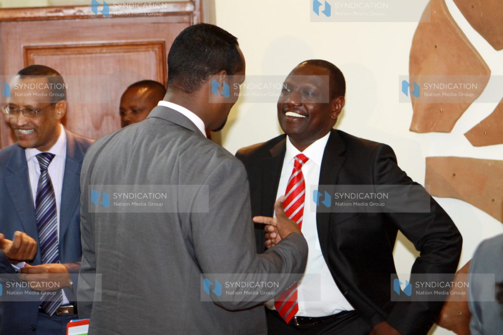 Deputy president William Ruto chats Mandera Governor Ali Ibrahim Roba