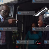 Kitui Senator David Musila speaks with a police officer