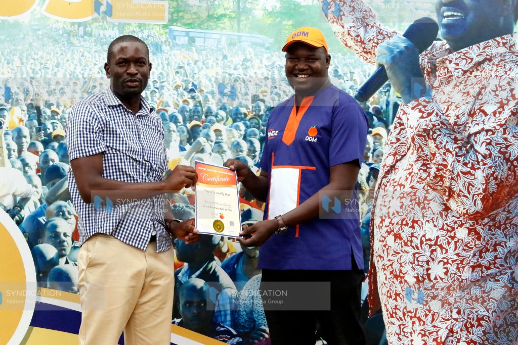 ODM Secretary General Edwin Sifuna presents a life membership certificate to Samuel Opinde