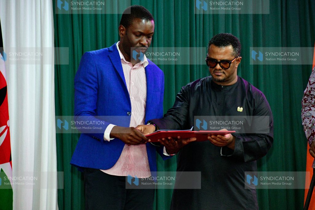 UDA Secretary General Hassan Omar exchanges documents ODM Secretary General Edwin Sifuna