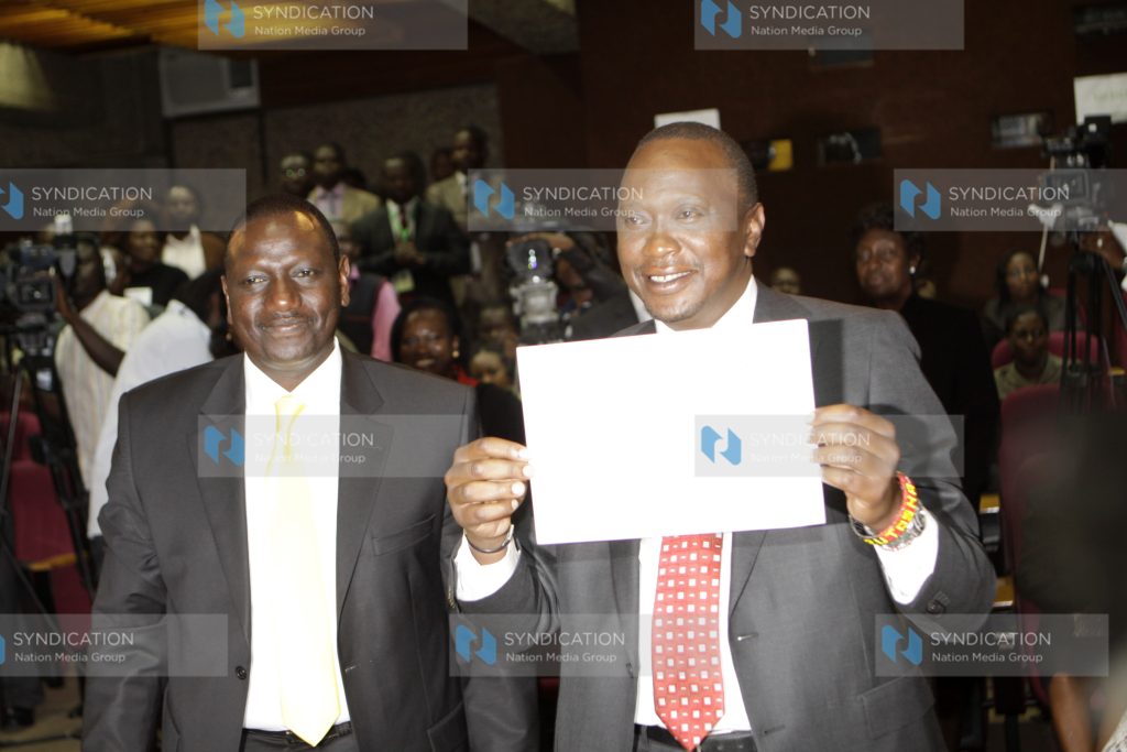 Uhuru Kenyatta shows off his certificate with his running mate William Ruto