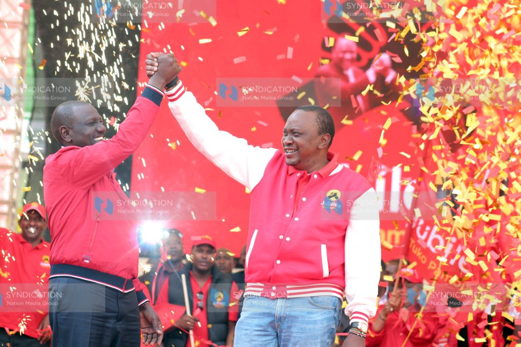 President Uhuru Kenyatta and his deputy William Ruto show Jubilee party sign during its launch