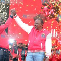 President Uhuru Kenyatta and his deputy William Ruto show Jubilee party sign during its launch