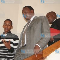 Junior sergeant-at-arms Tevin Waiguru, chats with finance minister Uhuru Kenyatta