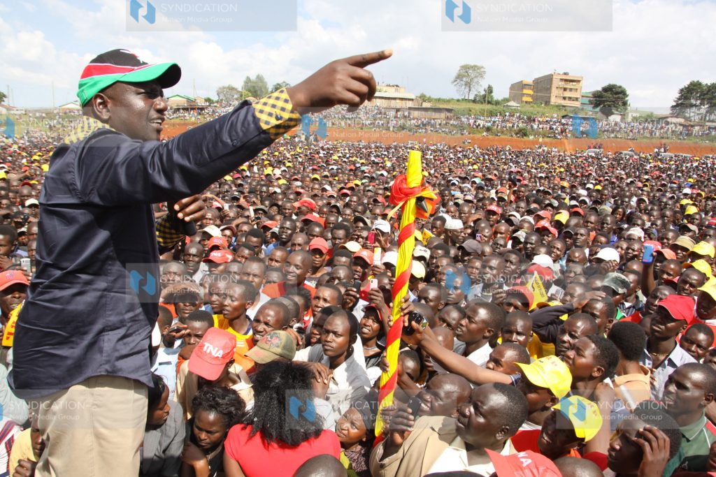 Jubilee Coalition presidential candidate Uhuru Kenyatta’s his running mate William Ruto addresses a rally