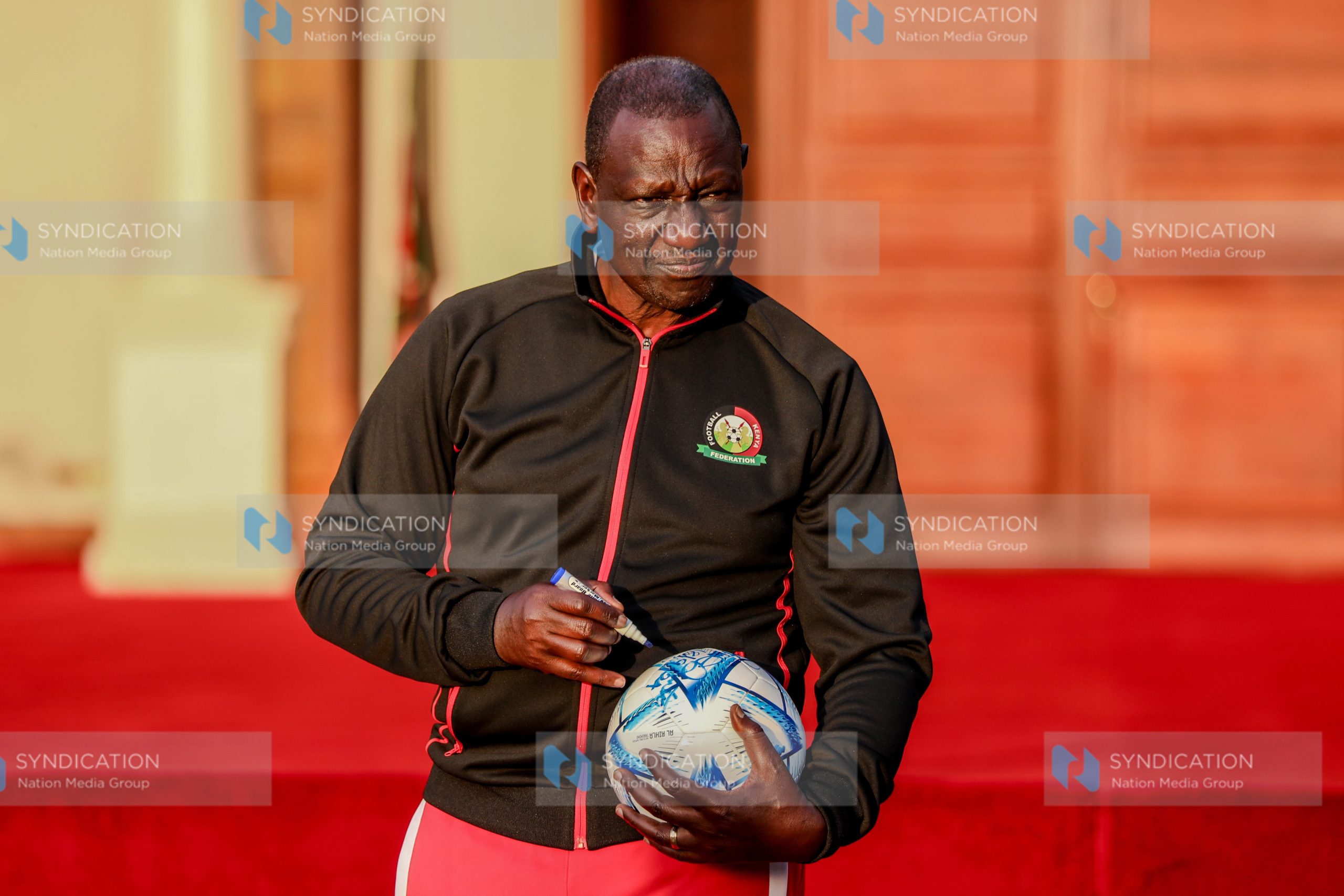 President William Ruto signs a football during the flagging off of the Junior Starlets football team