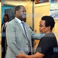 ODM party leader Raila Odinga is welcomed by Mary Kangethe Kadenge, wife of the late football legend Joe Kadenge