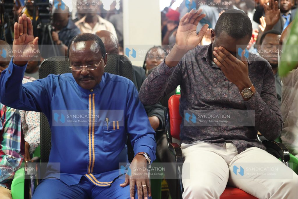 ODM Secretary General Edwin Sifuna raising their hands for prayers