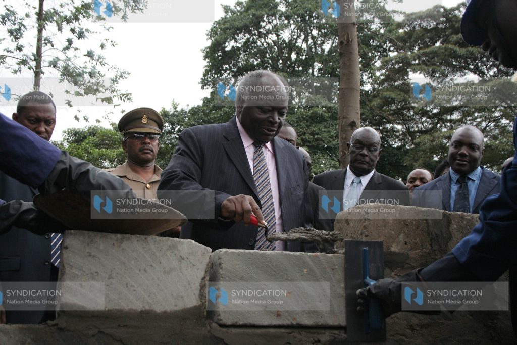 President Mwai Kibaki lays a foundation stone for the centenary hostel