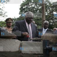 President Mwai Kibaki lays a foundation stone for the centenary hostel