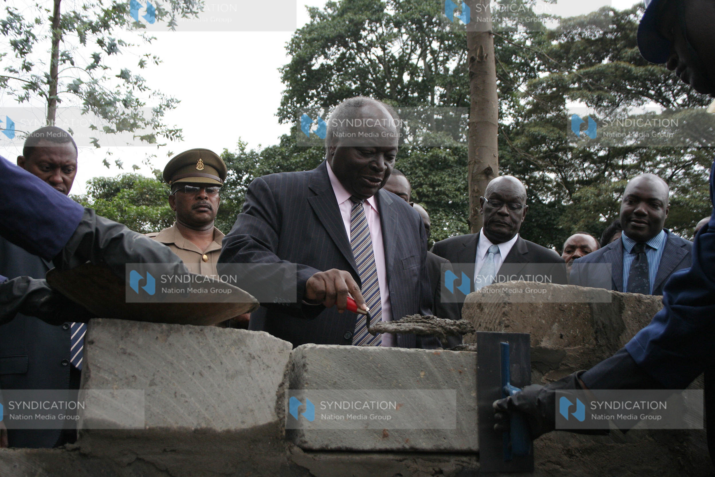 President Mwai Kibaki lays a foundation stone for the centenary hostel