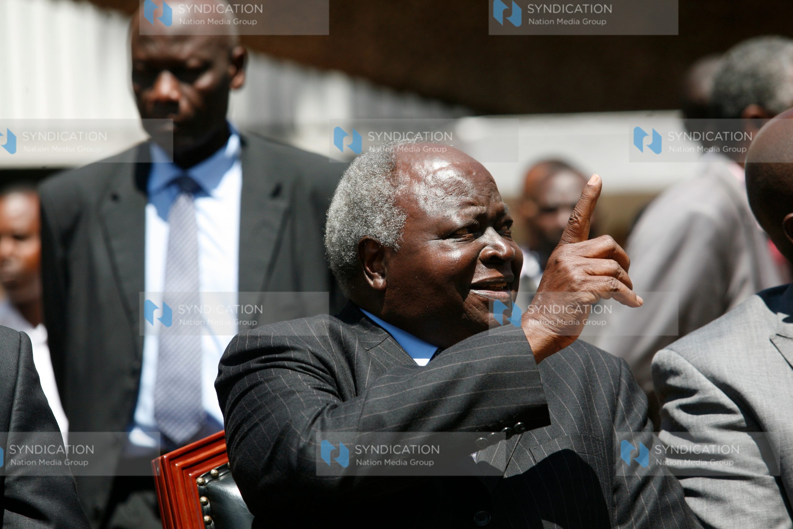Former President Mwai Kibaki gestures at the University of Nairobi