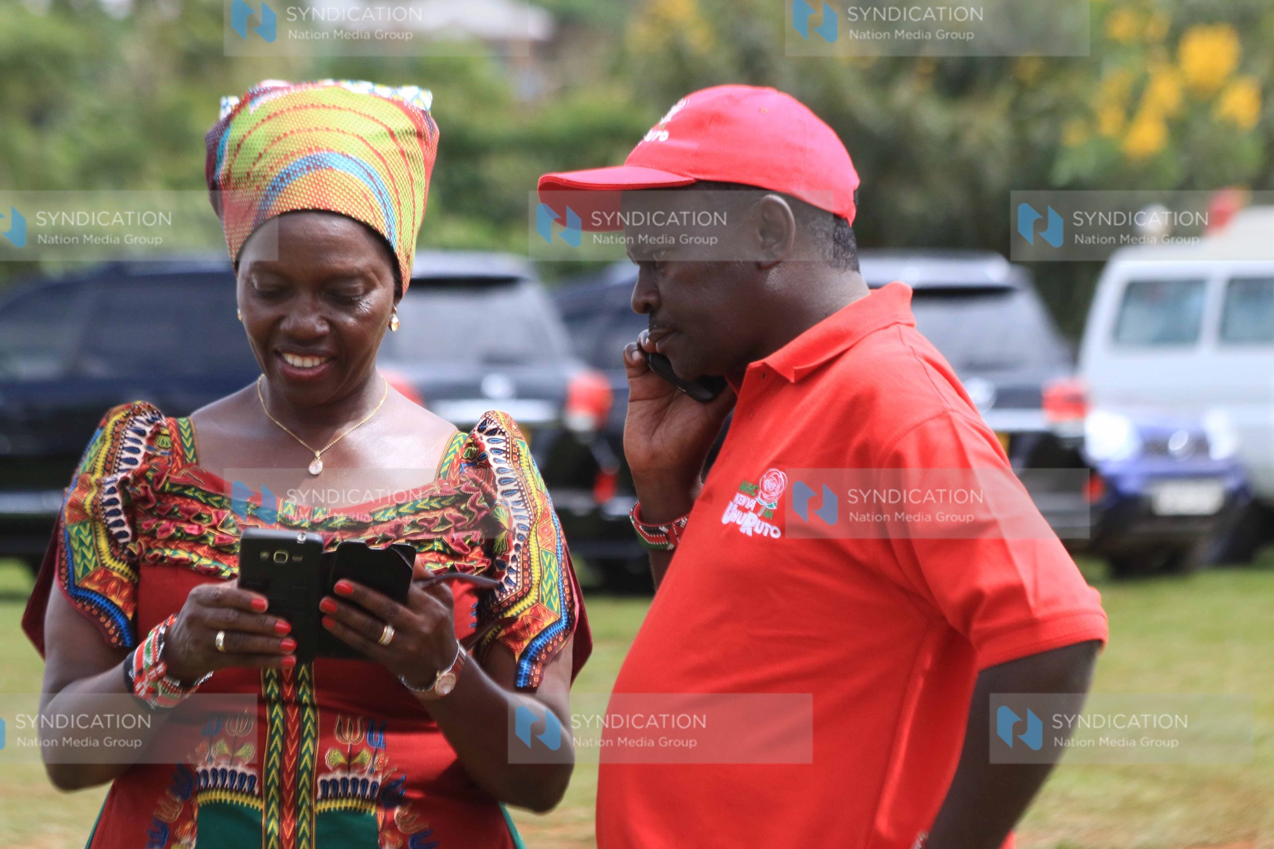 Martha Karua chats with her running mate Joseph Gitari(right)