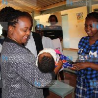 Anne Waiguru holds a baby at Kimbimbi Hospital