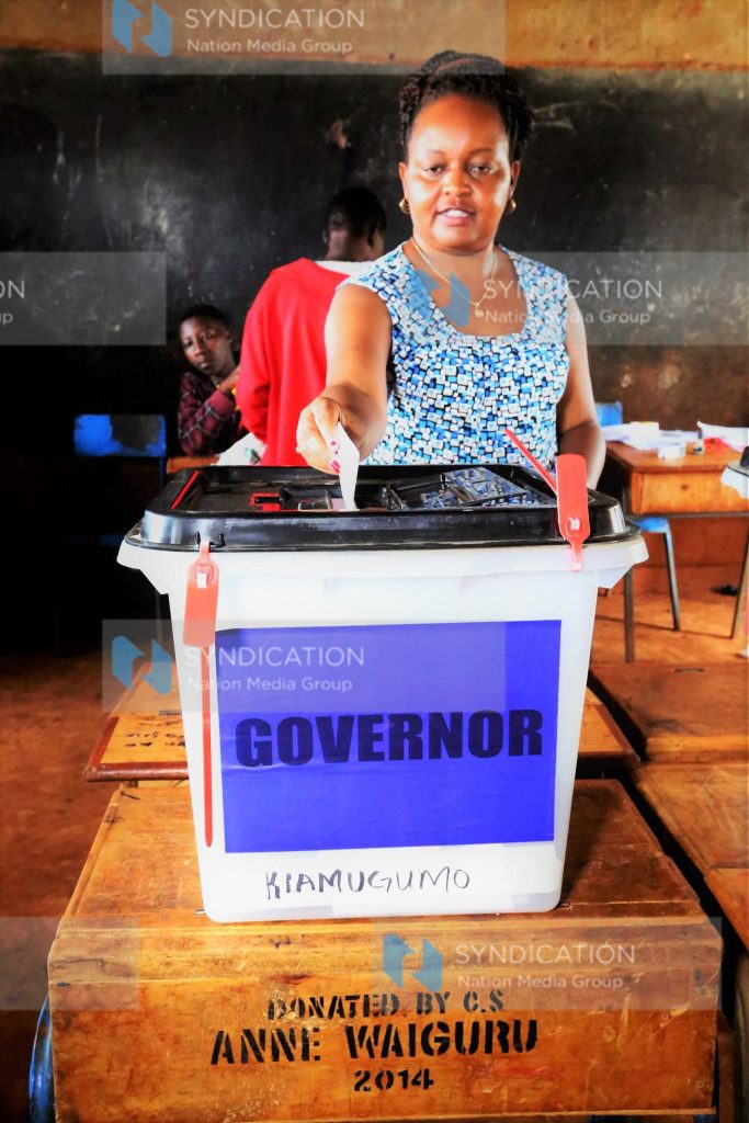 Anne Waiguru casts her vote at Kiawamugumo polling centre