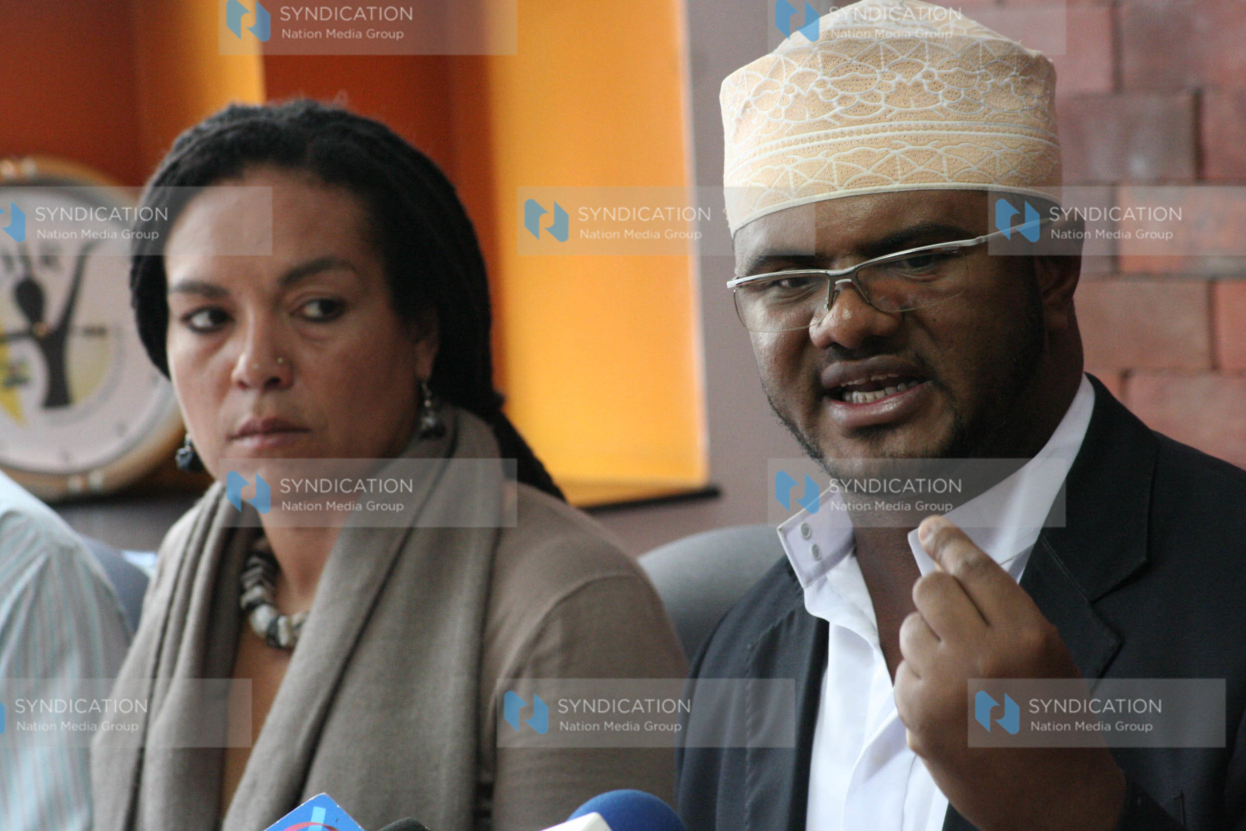 Hassan Omar (righ) flanked by KHRC executive director Muthoni Wanyeki address a press conference