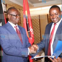 Kiraitu Murungi presents the new Youth executive James Koome (Right) with contract documents