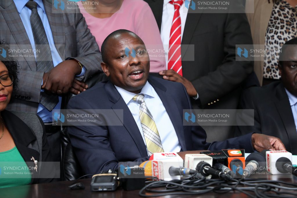 Kimani Ichung’wah addressing the media at parliament buildings
