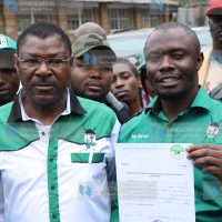 Eng. Khamisi Butichi (right) displays his IEBC clearance certificate