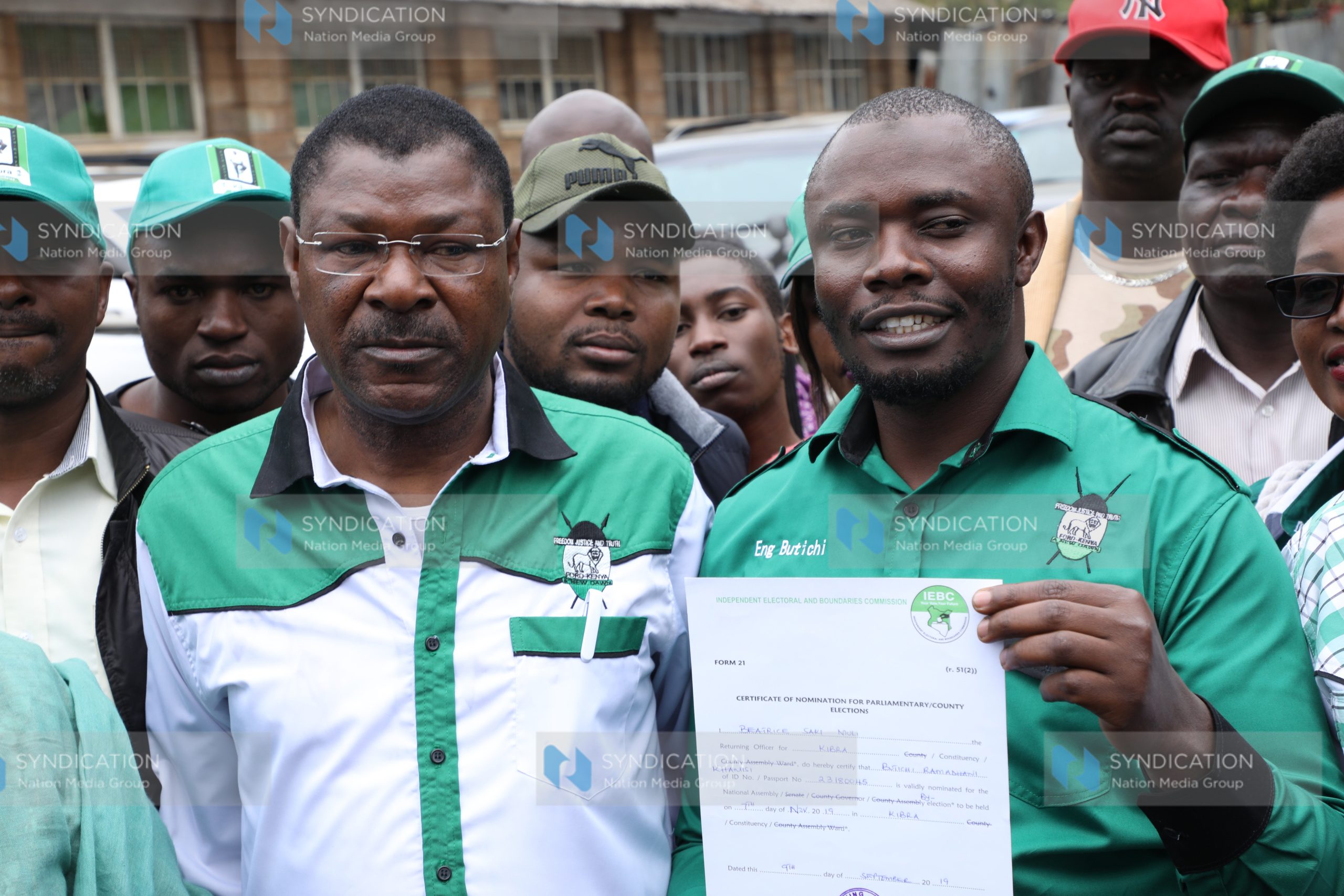 Eng. Khamisi Butichi (right) displays his IEBC clearance certificate