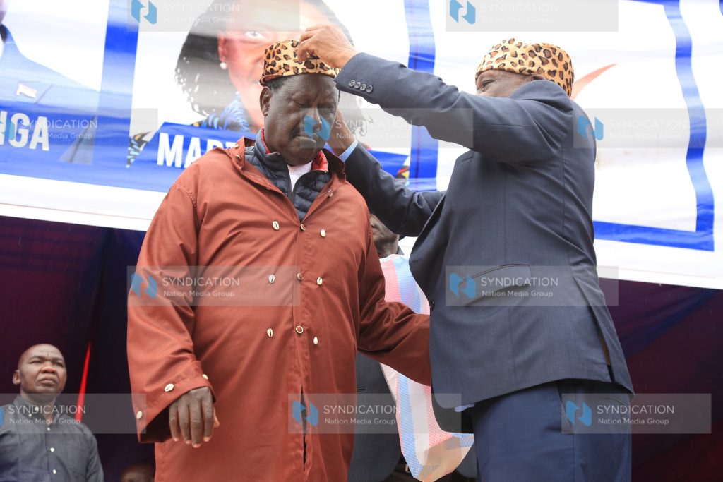 Raila Odinga (left) is installed as a Kisii elder