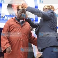 Raila Odinga (left) is installed as a Kisii elder