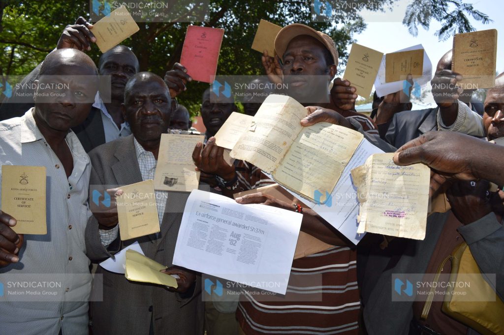 Kenya Air Force ex-servicemen display their discharge certificates